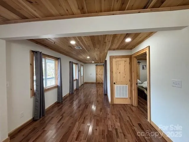 a view of hallway with wooden floor and stairs