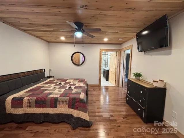 a bedroom with a bed and flat screen tv