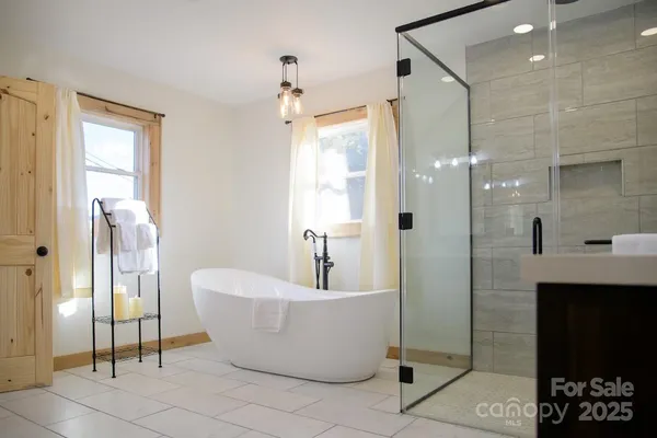 a bathroom with a bathtub and shower