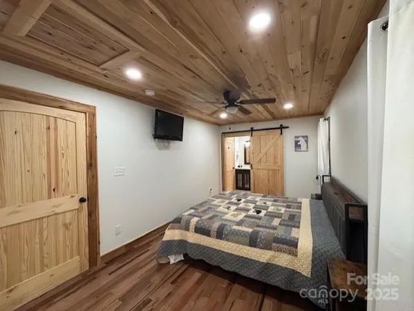 a bedroom with a bed and a mirror