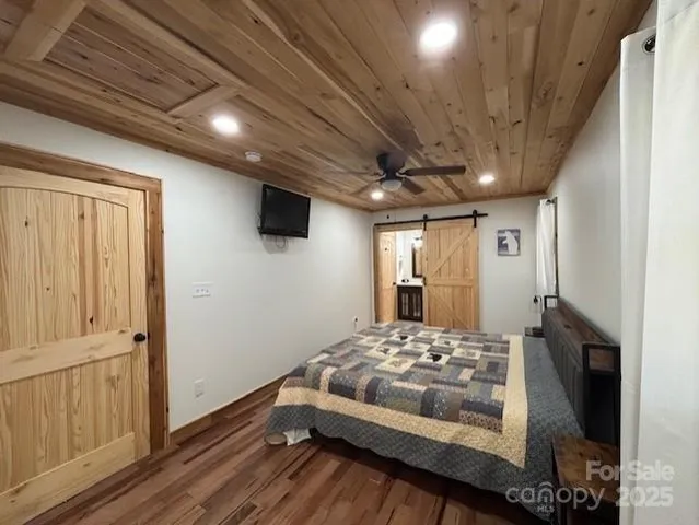 a bedroom with a bed and a mirror