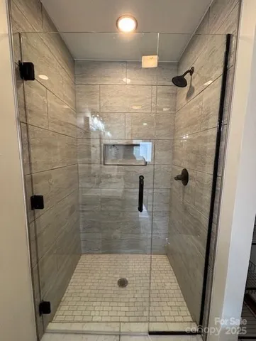 a bathroom with a shower and mirror