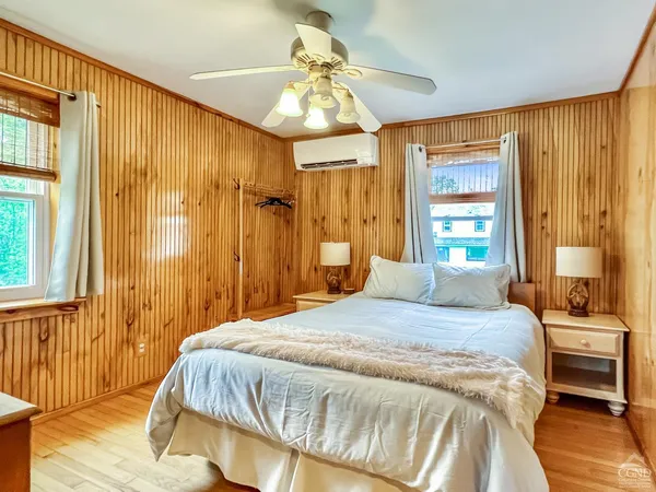 a bedroom with a bed and a chandelier