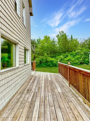 a view of balcony with wooden floor and fence