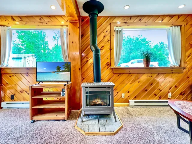 a front door view of patio with a fireplace and a bathtub