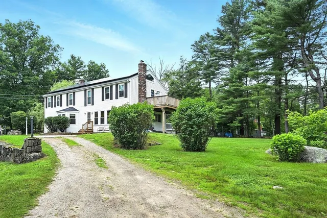 a view of a house with yard and a garden