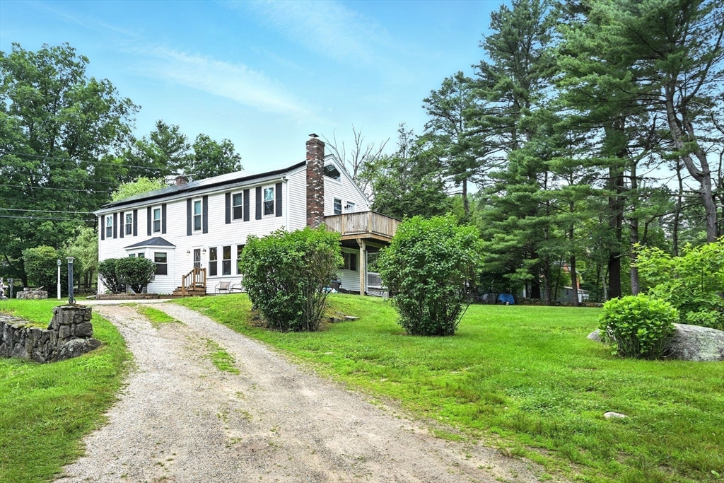 a view of a house with yard and a garden