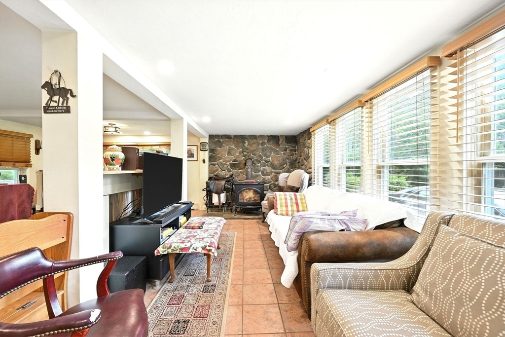 23 Westboro Road Upton, MA 01568 - Photo 12 of 42 a living room with furniture and a flat screen tv