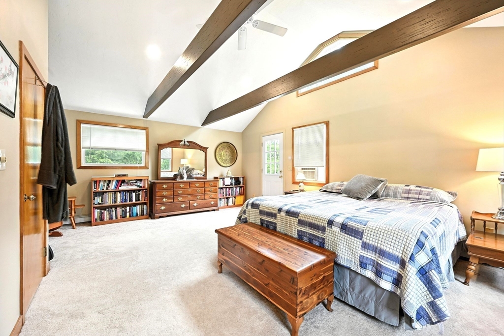 23 Westboro Road Upton, MA 01568 - Photo 20 of 42 a spacious bedroom with a bed a table and large windows