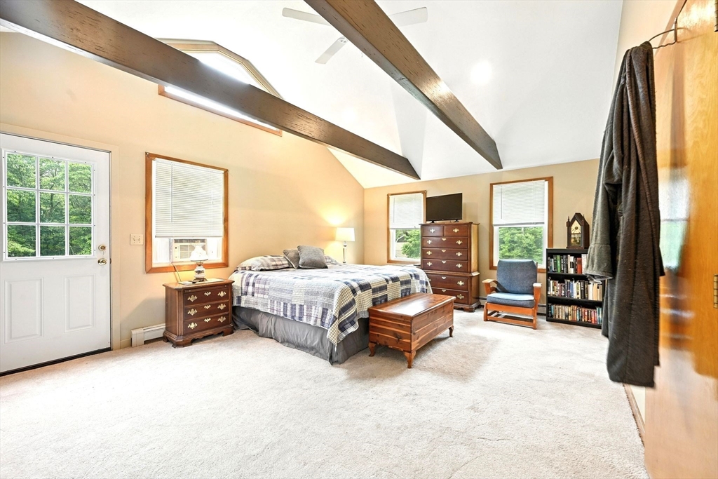 23 Westboro Road Upton, MA 01568 - Photo 22 of 42 a spacious bedroom with a bed couch and a large window