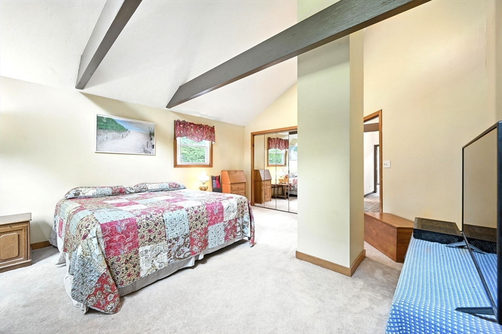 23 Westboro Road Upton, MA 01568 - Photo 24 of 42 a bedroom with a bed and a large mirror on the dresser