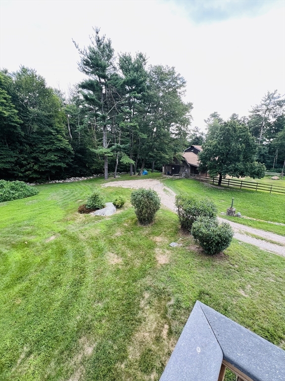 23 Westboro Road Upton, MA 01568 - Photo 30 of 42 a view of a garden with a bench and trees