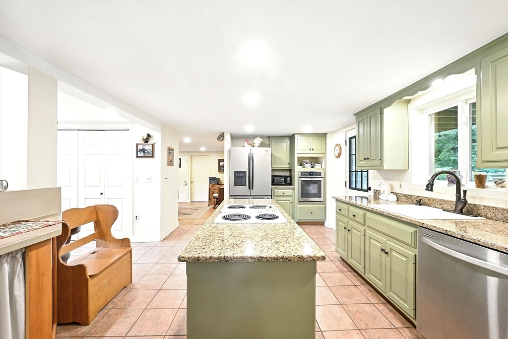 23 Westboro Road Upton, MA 01568 - Photo 6 of 42 a large kitchen with granite countertop a sink and dishwasher stove