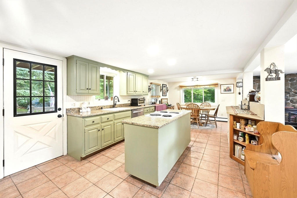 23 Westboro Road Upton, MA 01568 - Photo 9 of 42 a kitchen with appliances cabinets and a table