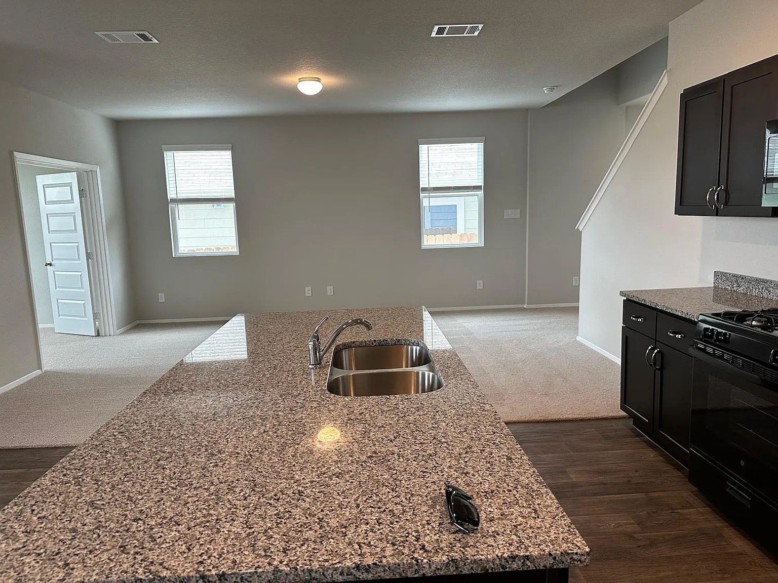 11516 Murano Drive Austin, TX 78747 - Photo 3 of 23 a kitchen with stainless steel appliances granite countertop a stove a sink and a microwave