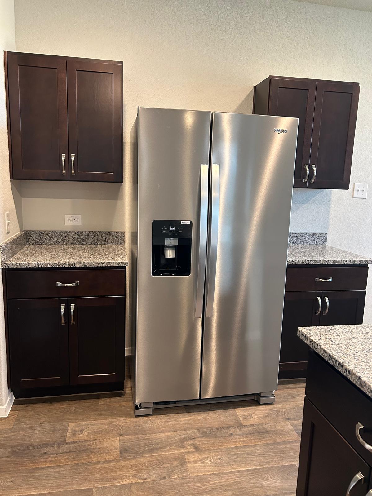 11516 Murano Drive Austin, TX 78747 - Photo 4 of 23 a kitchen with stainless steel appliances granite countertop a refrigerator and a stove