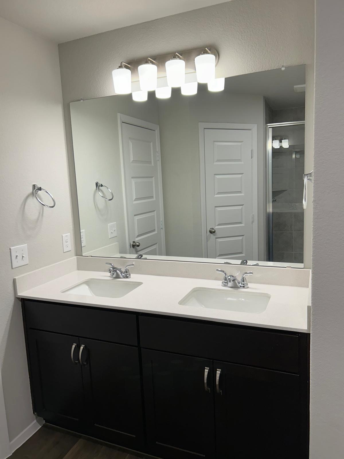11516 Murano Drive Austin, TX 78747 - Photo 7 of 23 a bathroom with a double vanity sink and a mirror