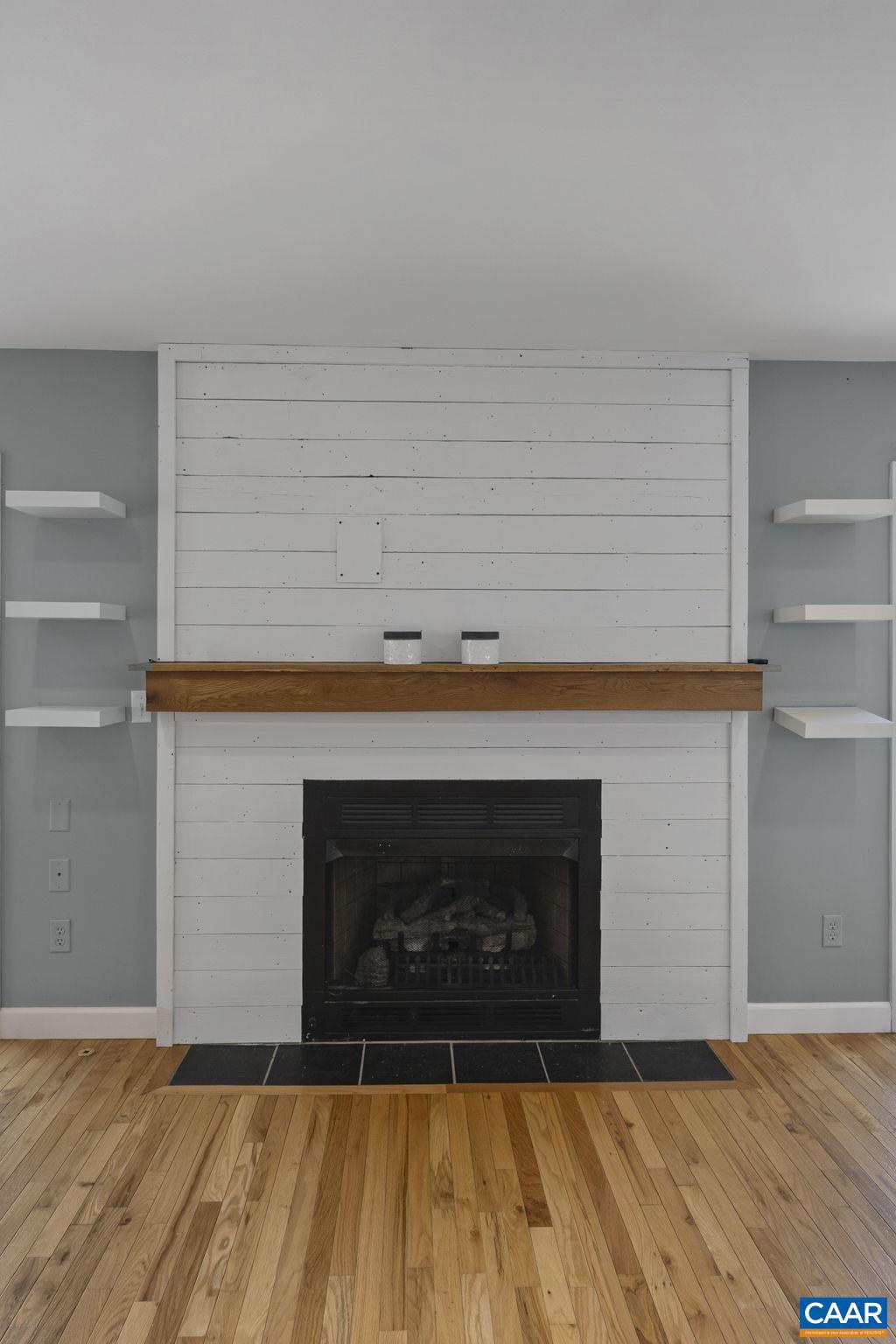379 Fox Ridge Lane Palmyra, VA 22963 - Photo 11 of 42 a living room with a fireplace and a wooden floor