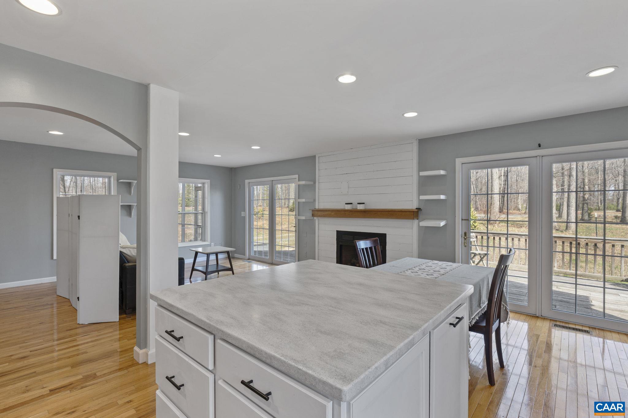 379 Fox Ridge Lane Palmyra, VA 22963 - Photo 15 of 42 a kitchen with a table chairs refrigerator and cabinets