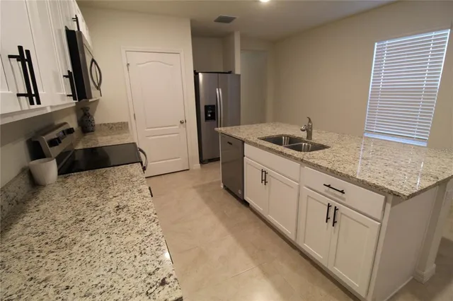 a close view of a sink and cabinets
