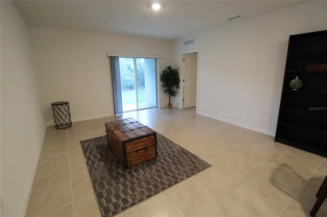 a bedroom with a bed lamp and a window