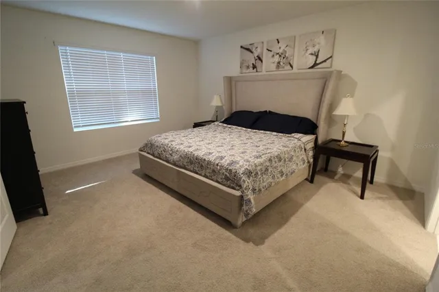 a bedroom with a bed and window