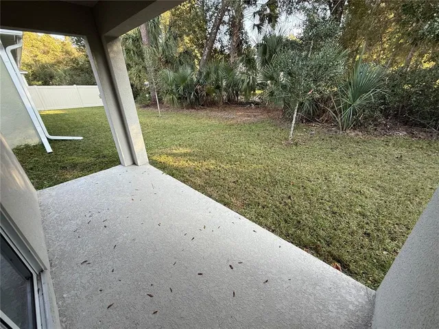 a view of a back yard from a corridor