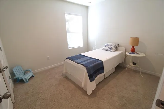 a spacious bedroom with a bed and a window