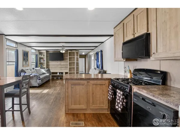 a kitchen with sink a stove and cabinets