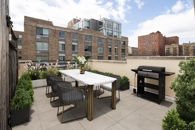 a view of a patio with table and chairs and potted plants