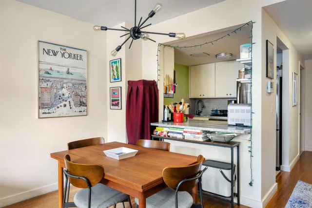 a view of a dining room with furniture and a chandelier