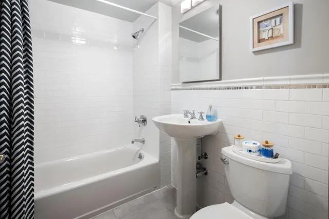 a bathroom with a sink mirror vanity and toilet
