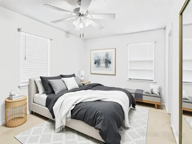 a bedroom with a large bed and a window