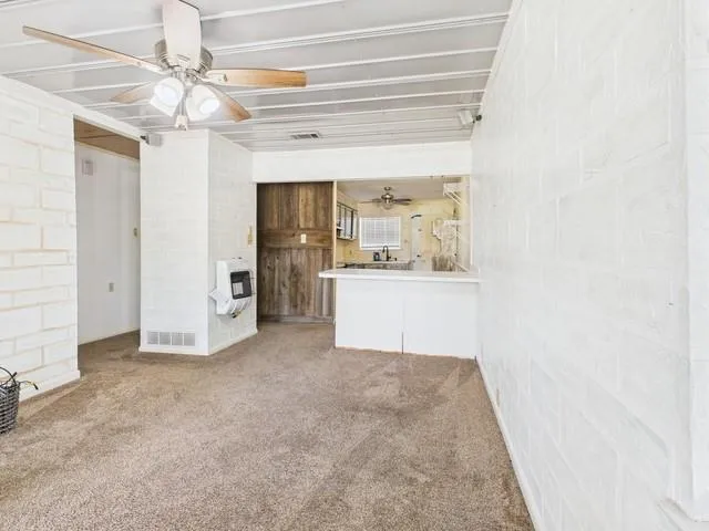 a view of a kitchen with a sink and cabinets