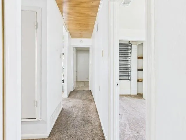 a view of a hallway with a white door