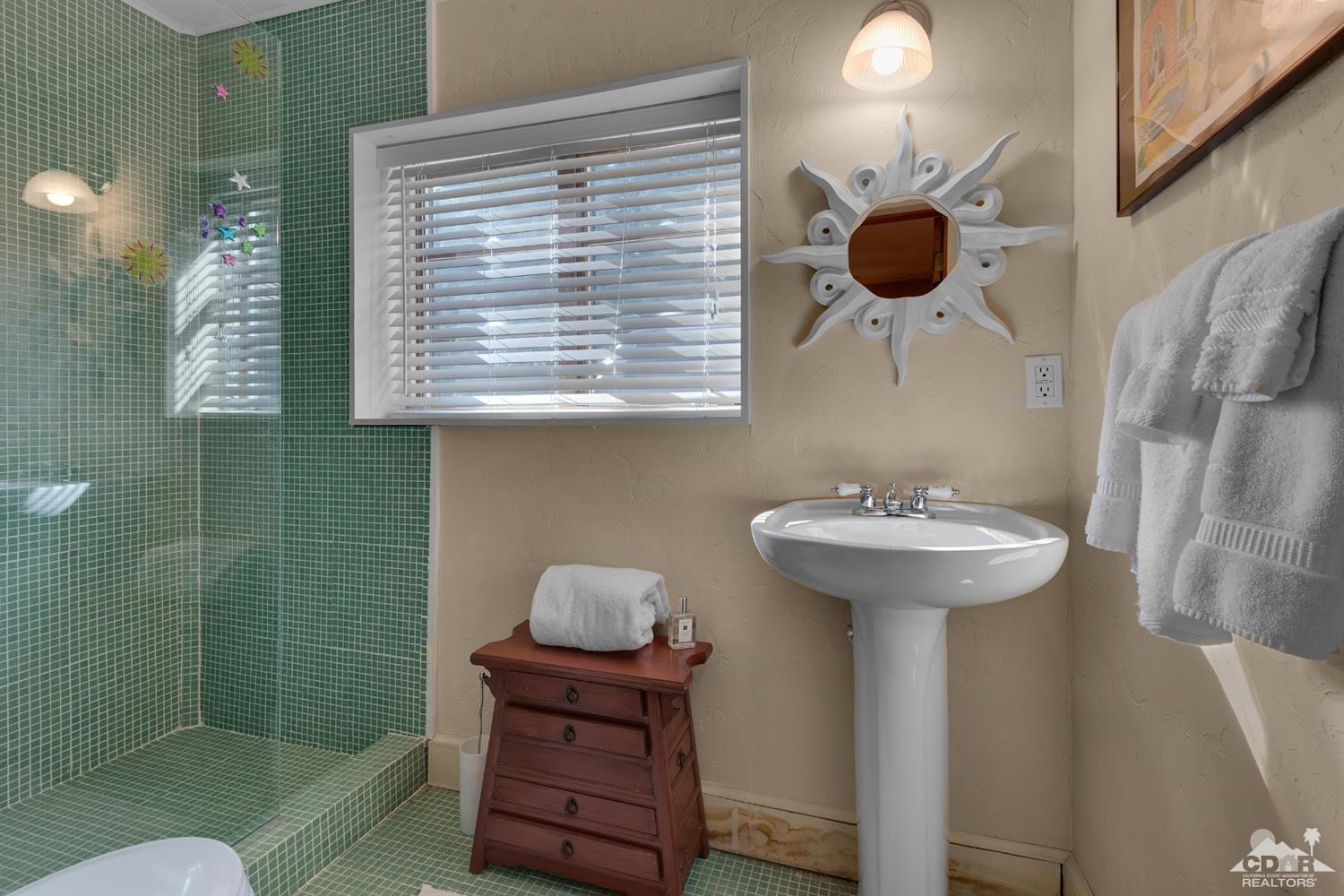 72220 Rancho Road Rancho Mirage, CA 92270 - Photo 12 of 24 a bathroom with a sink and a mirror