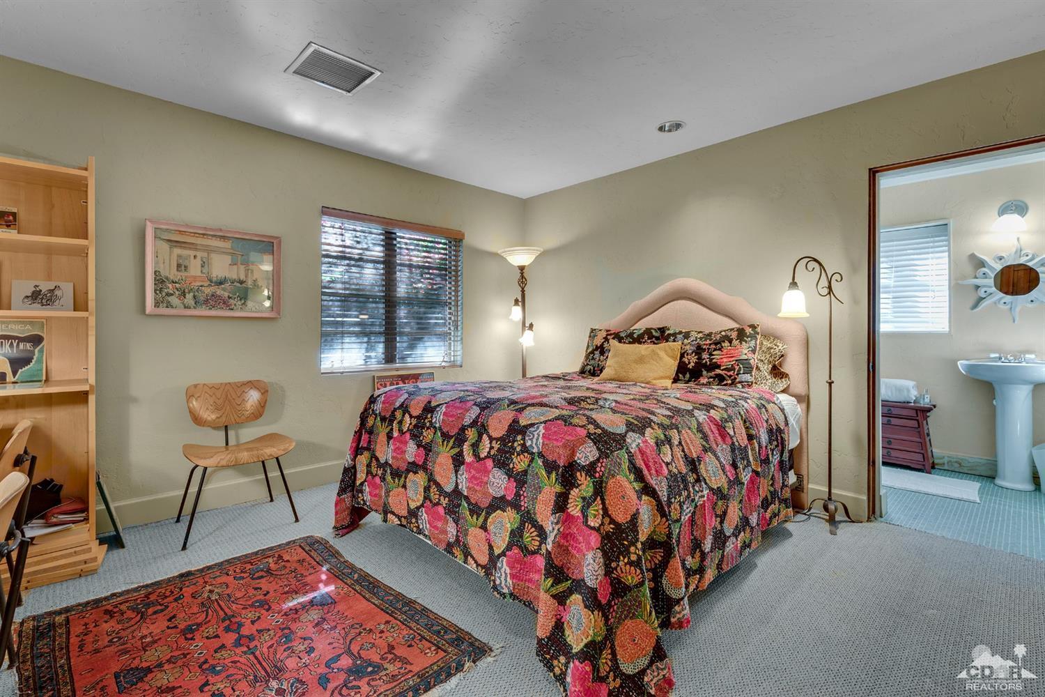72220 Rancho Road Rancho Mirage, CA 92270 - Photo 13 of 24 a bedroom with a bed and a table in it