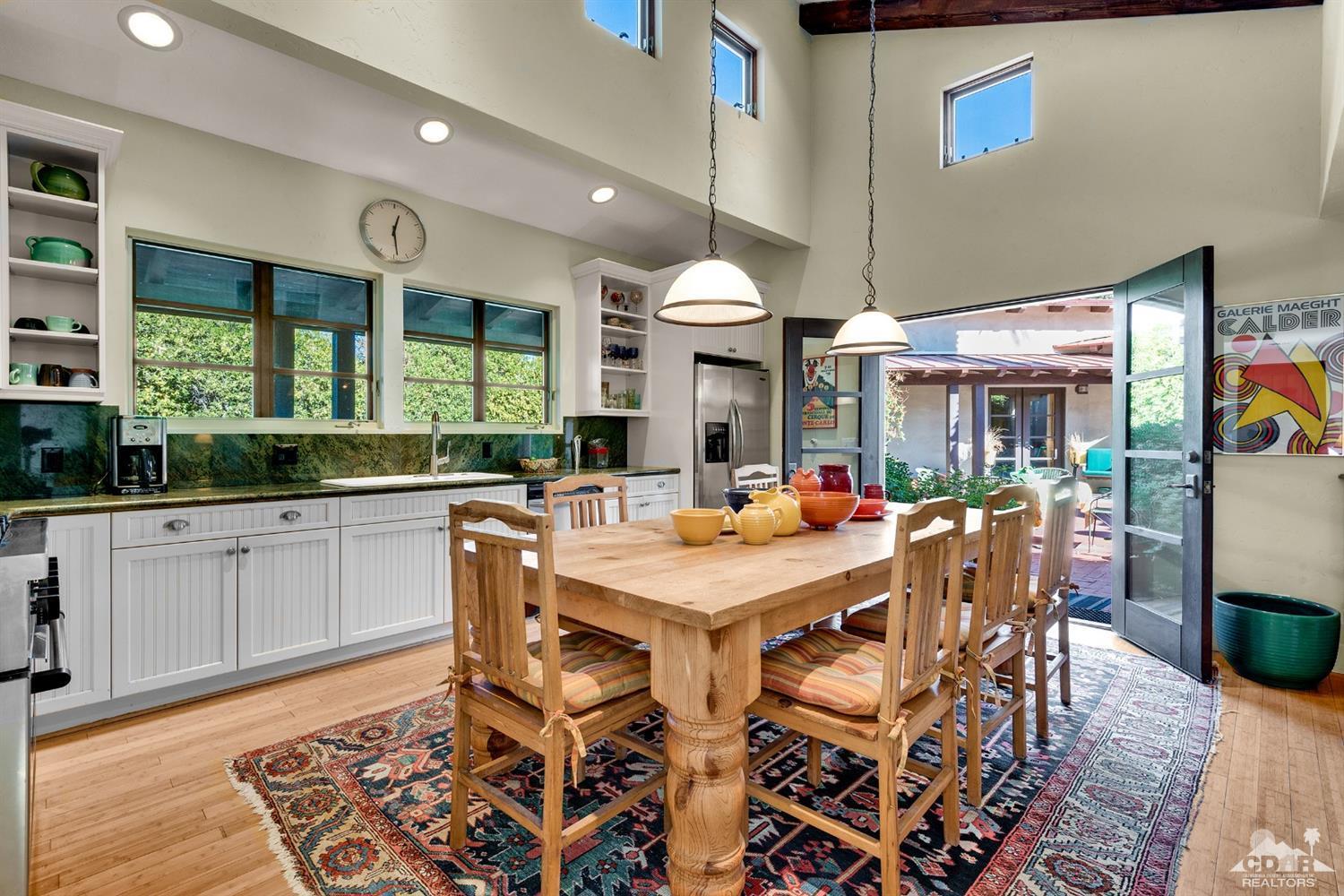 72220 Rancho Road Rancho Mirage, CA 92270 - Photo 15 of 24 a large kitchen with a table and chairs
