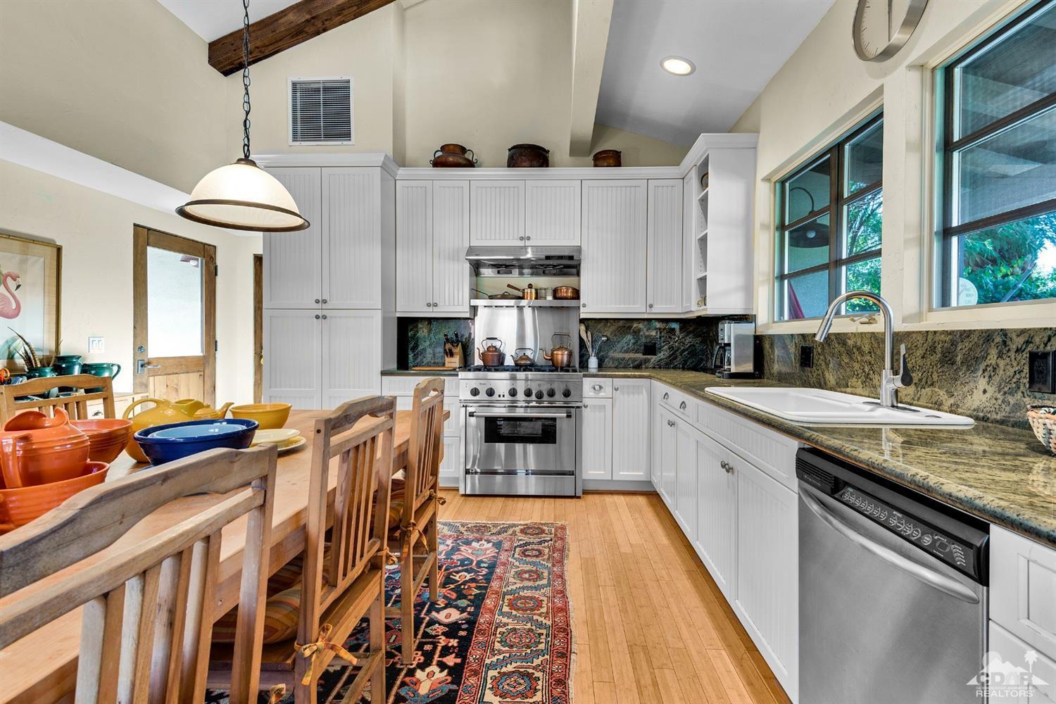 72220 Rancho Road Rancho Mirage, CA 92270 - Photo 16 of 24 a kitchen with stainless steel appliances granite countertop a stove a sink and a refrigerator
