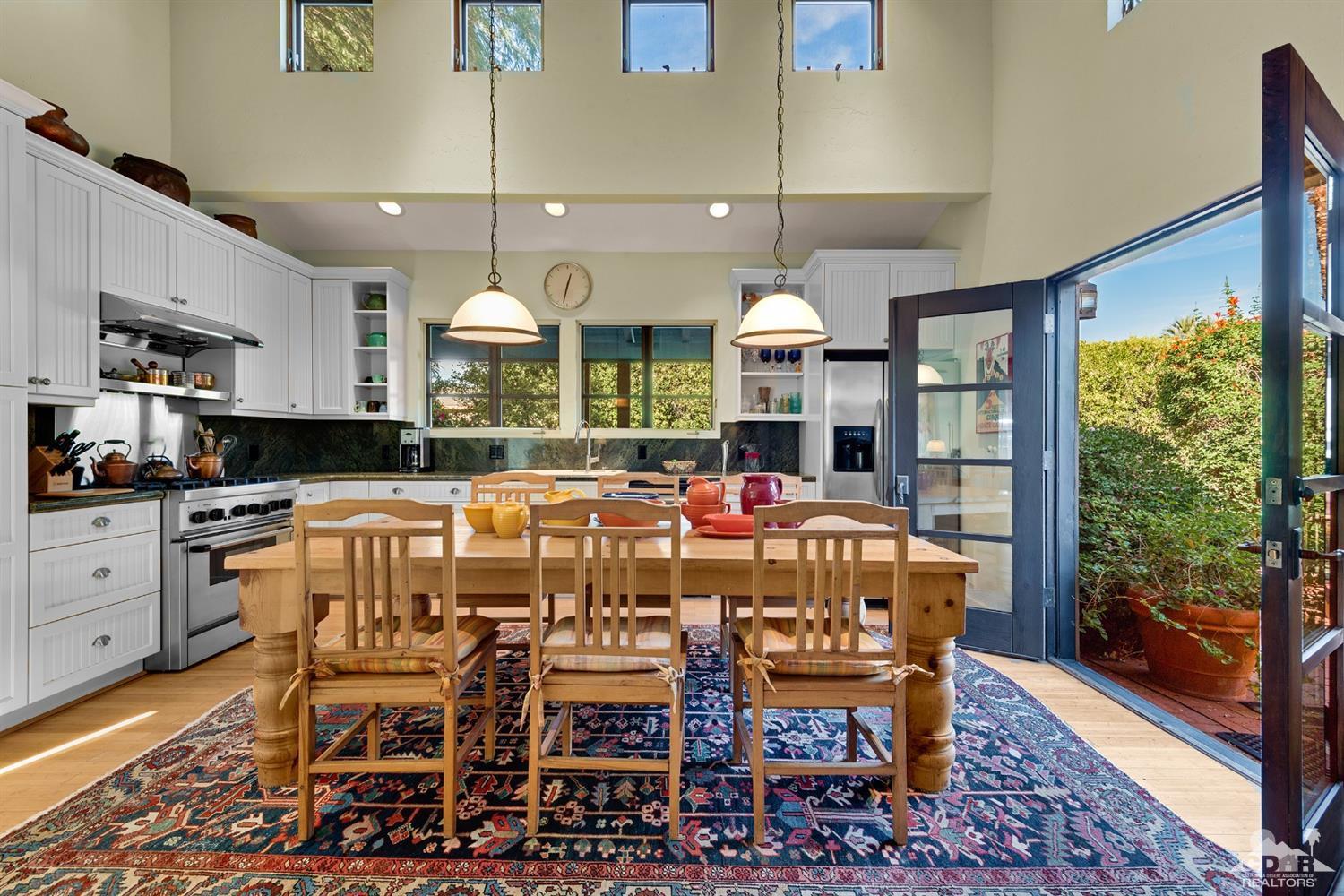 72220 Rancho Road Rancho Mirage, CA 92270 - Photo 18 of 24 a large kitchen with a table and chairs in it