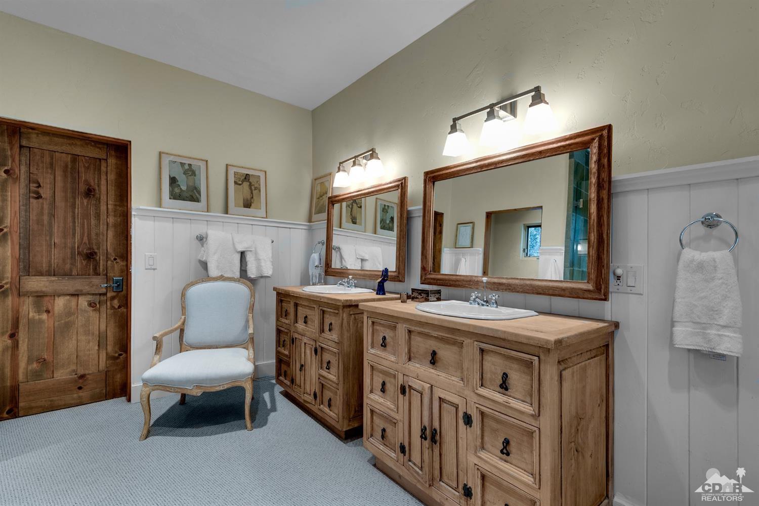 72220 Rancho Road Rancho Mirage, CA 92270 - Photo 22 of 24 a spacious bathroom with a double vanity sink and a mirror