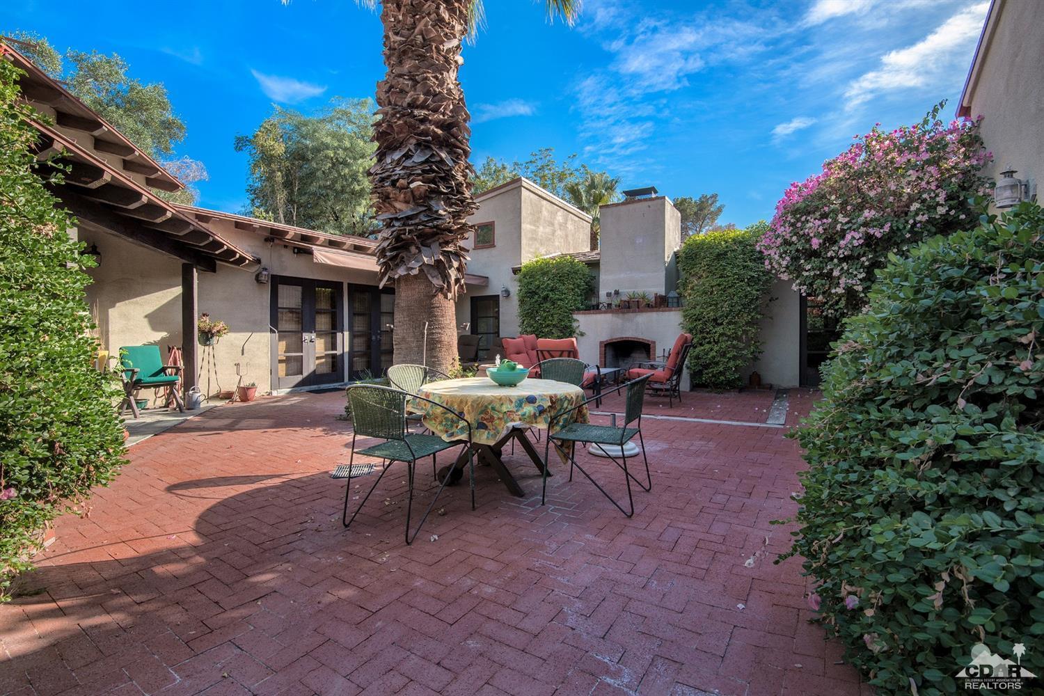 72220 Rancho Road Rancho Mirage, CA 92270 - Photo 4 of 24 a view of a patio with table and chairs and potted plants