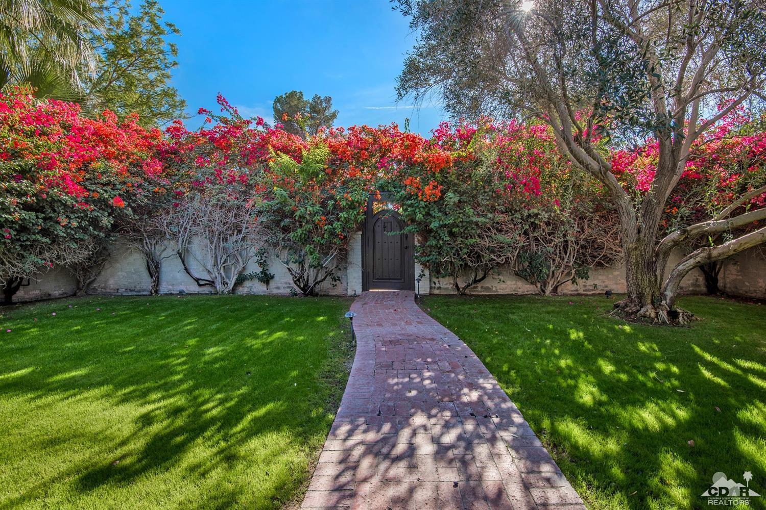 72220 Rancho Road Rancho Mirage, CA 92270 - Photo 7 of 24 a front view of a house with garden