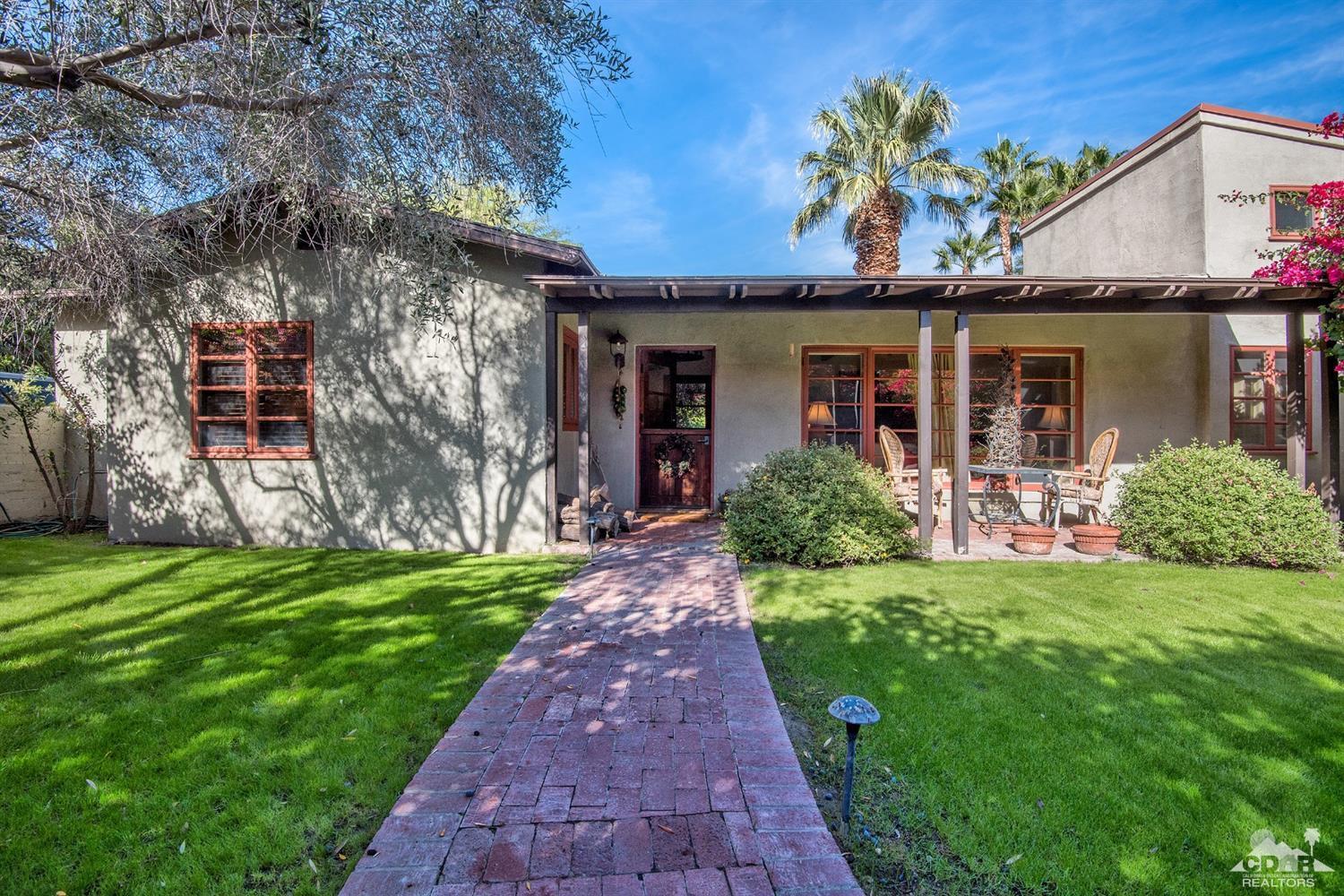 72220 Rancho Road Rancho Mirage, CA 92270 - Photo 9 of 24 a front view of a house with a garden