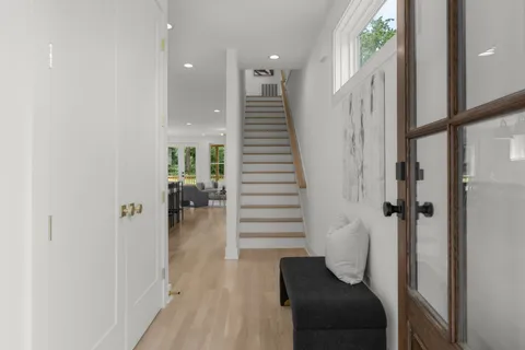 a bathroom with a granite countertop sink a toilet and a mirror