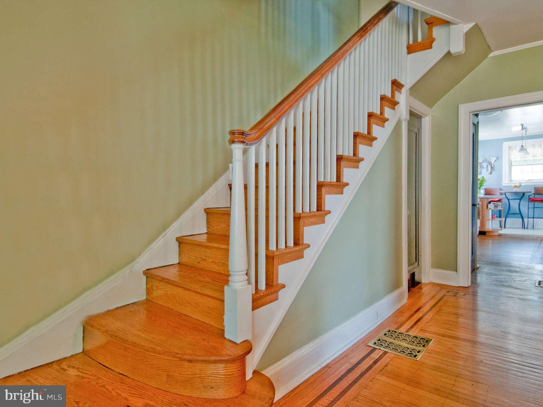 3614 Ednor Road Baltimore, MD 21218 - Photo 8 of 30 a view of staircase with lots of frames on wall and wooden floor