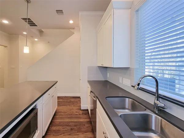 a kitchen that has a sink and a stove