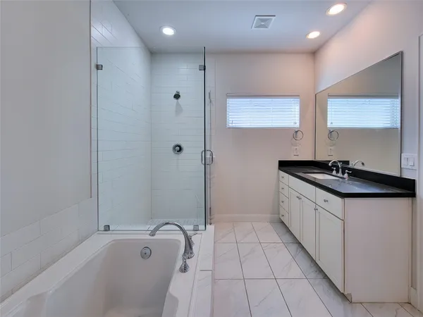 a bathroom with a tub and shower