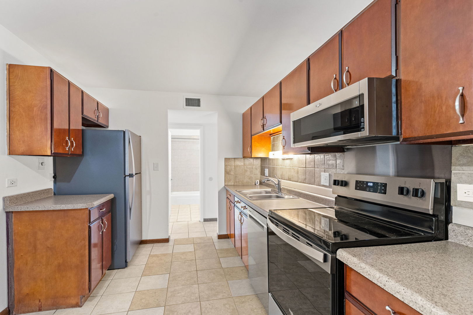 640 Murray Lane, Unit 111 Des Plaines, IL 60016 - Photo 4 of 19 a kitchen with a stove microwave and sink