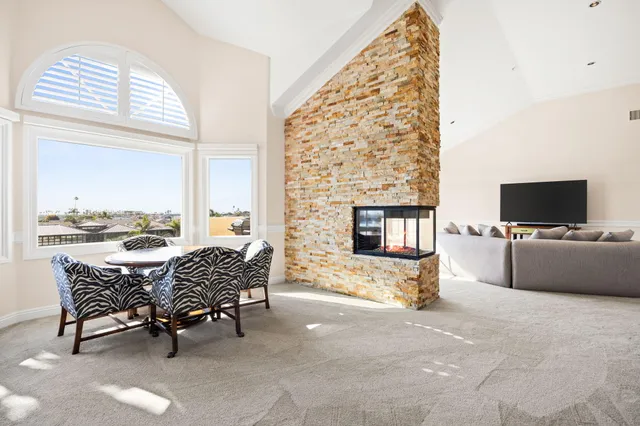 a bathroom with a granite countertop sink and a window